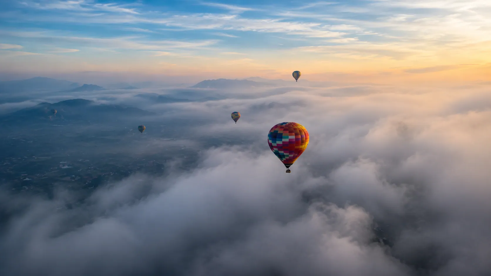 Hot air balloons drifting above a sea of clouds over the Teotihuacán valley at dawn